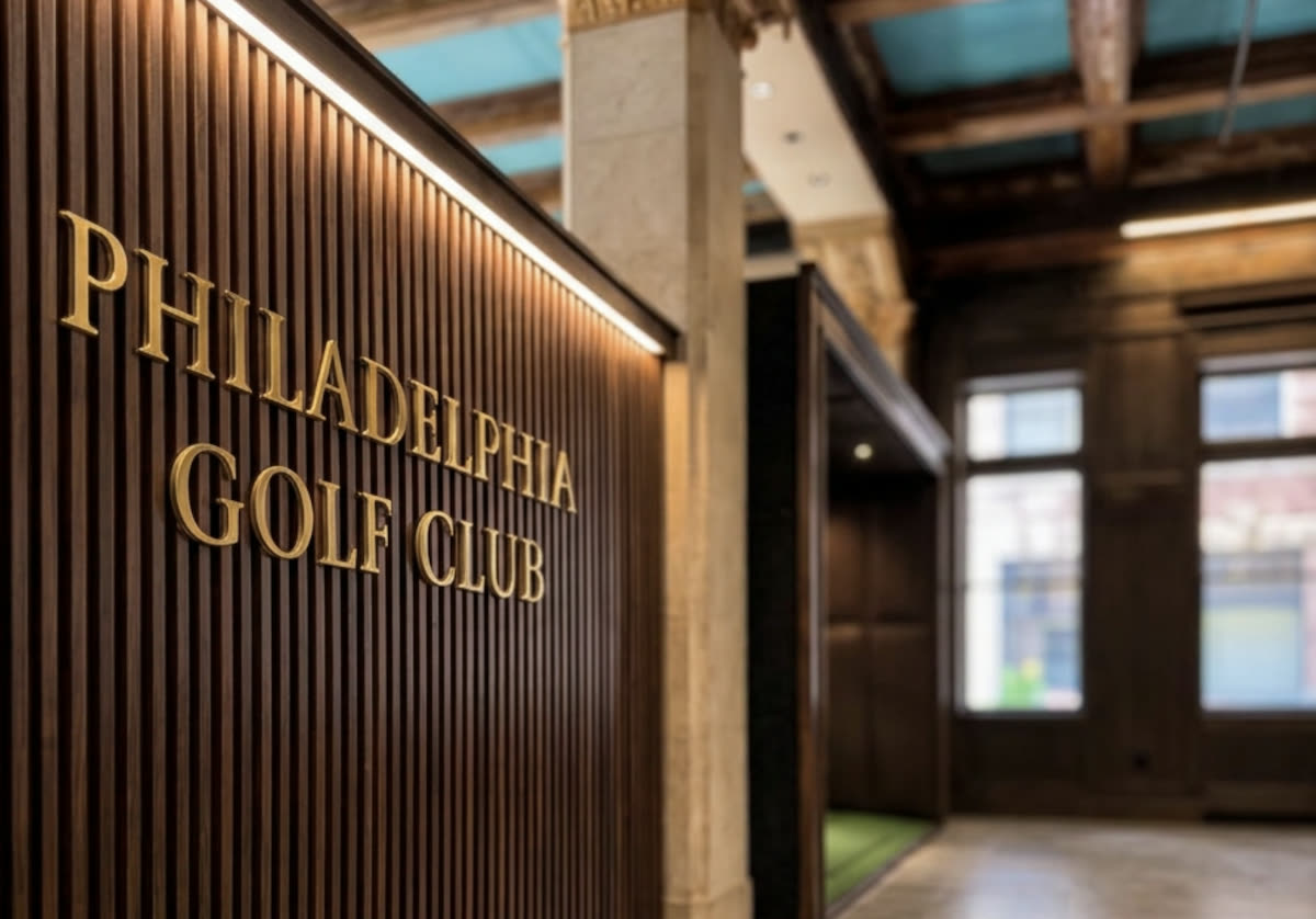 The Philadelphia Golf Club sign in gold lettering beside the bays